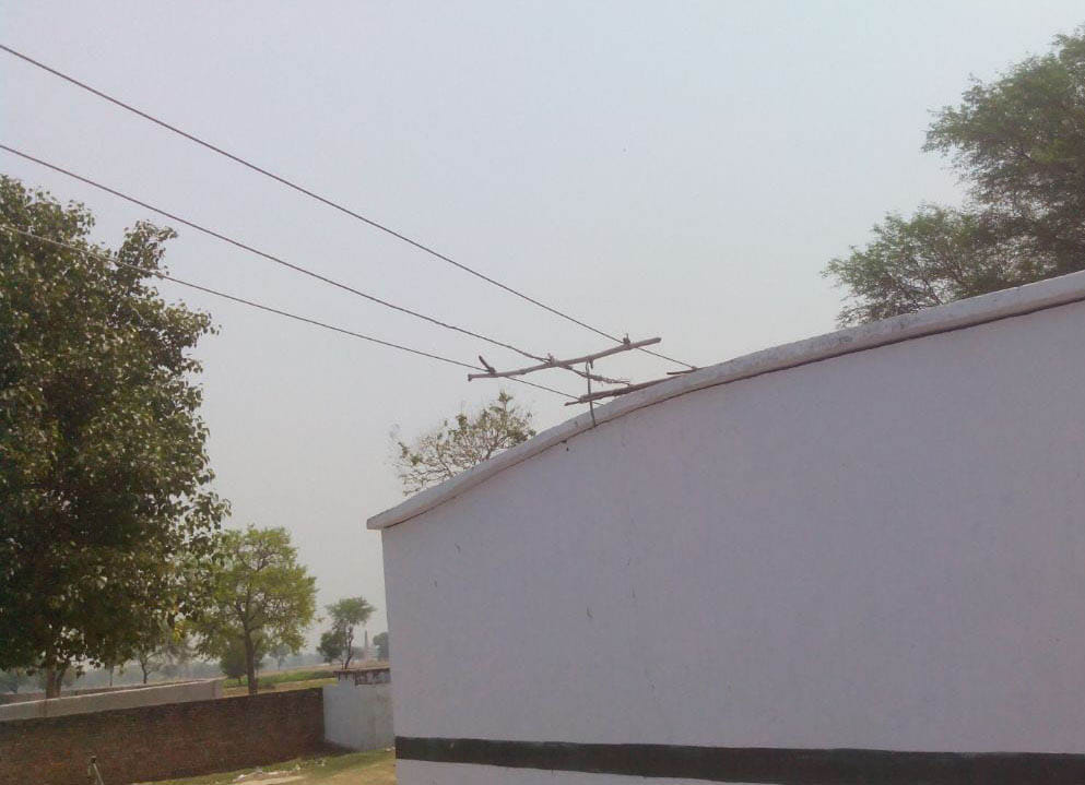 Shabby electric wire passing over the school