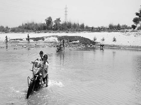 Bikes and bicycles are crossing river