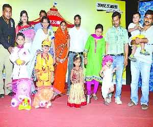 Children in Krishna and Radha's getup raised rock