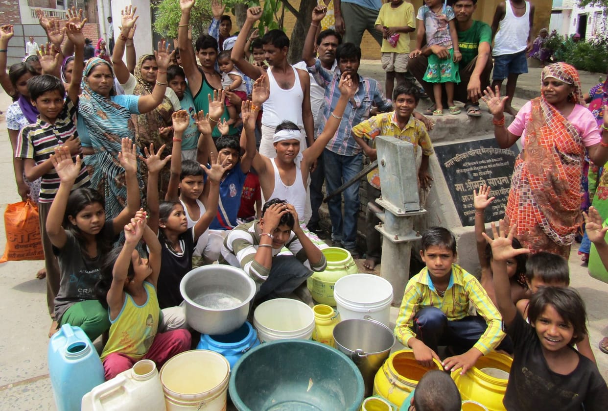 Trse people drinking water, hand pumps on line