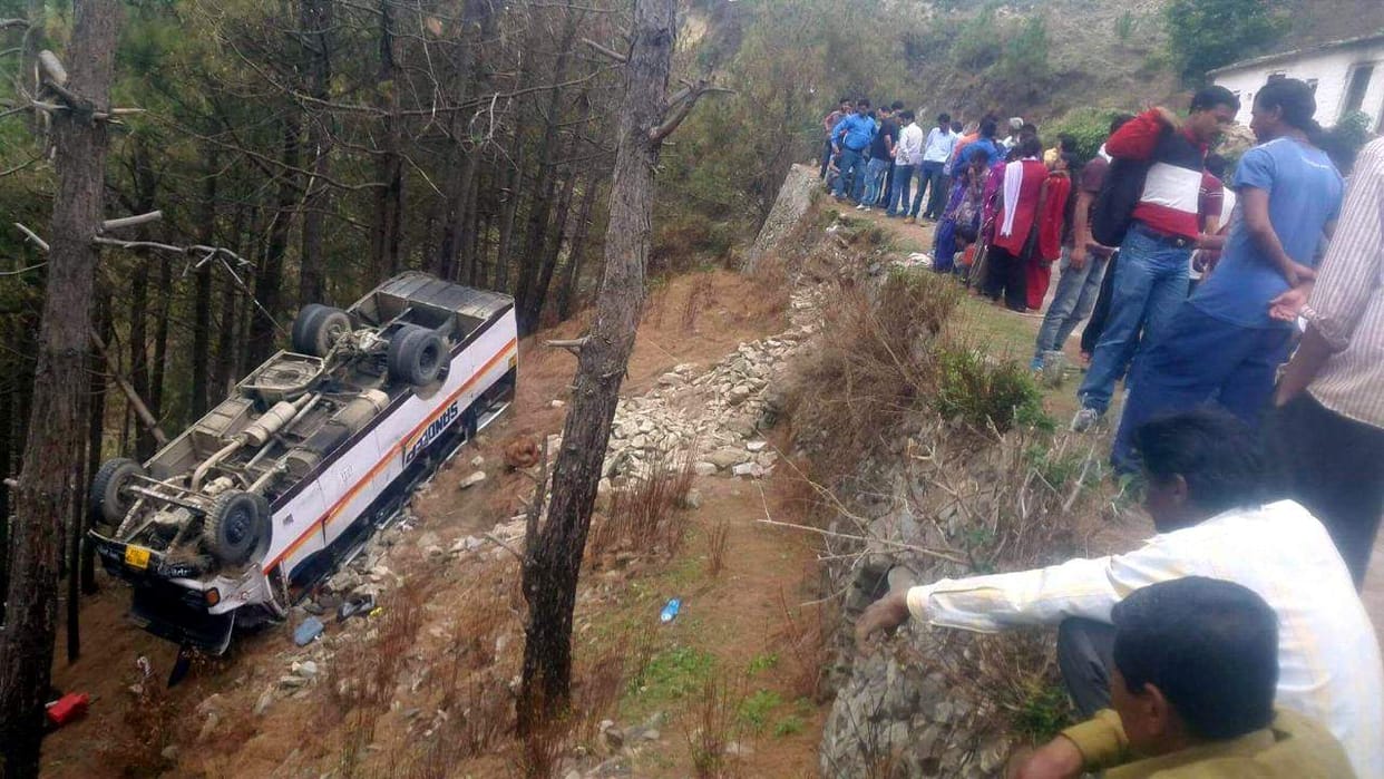 bus fell down in trench and hang on tree.
