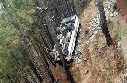 bus fell down in trench and hang on tree.
