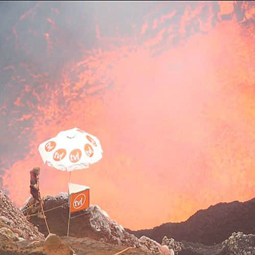 this man inside a volcano chatting on his mobile 