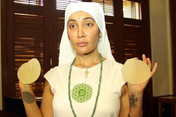 Sofia Hayat shows her breast implants at a press conference