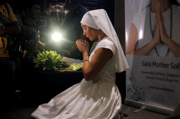 Sofia Hayat shows her breast implants at a press conference