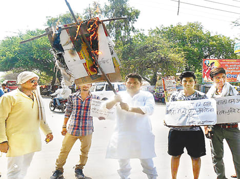 Burnt effigies against the Centre's policies