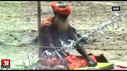  ‘Sadhu’ prays for rain by sitting inside ring of fire