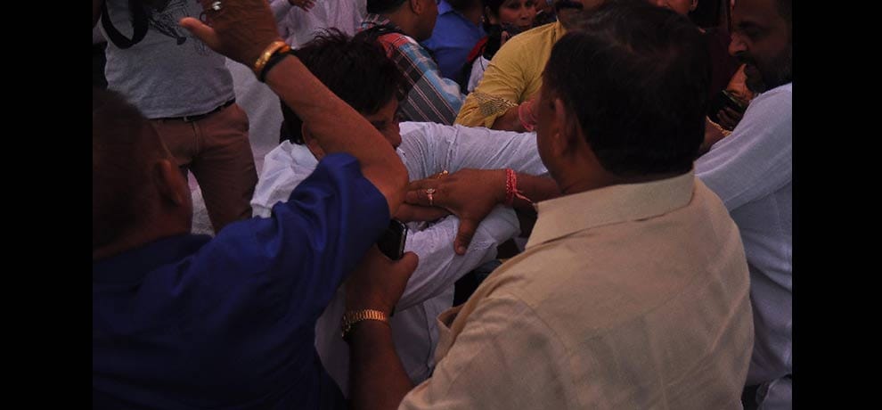 openly beating councilor for not removing topi on his head