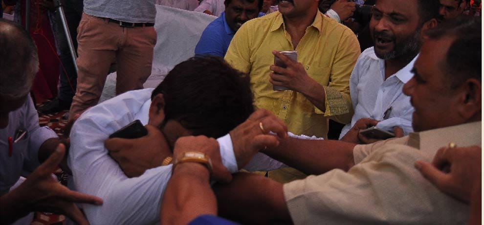 openly beating councilor for not removing topi on his head
