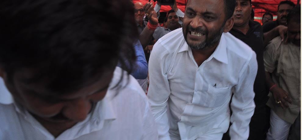 openly beating councilor for not removing topi on his head