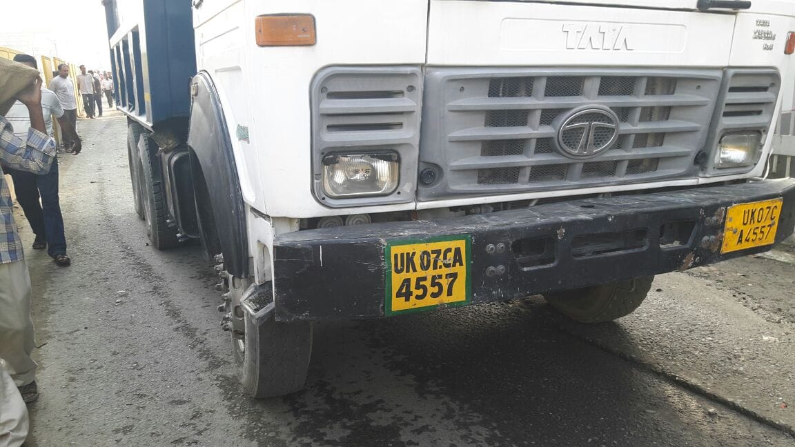 dumper hit the scooty, woman died.