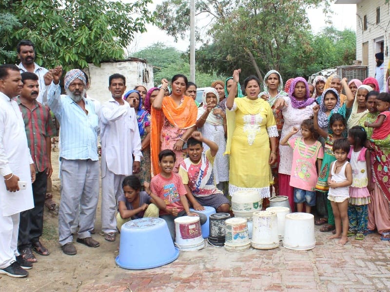 Slum area, the problem of water, empty bucket, performance, Sangrur