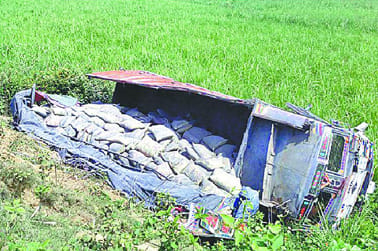 Cement -laden truck overturned along a highway