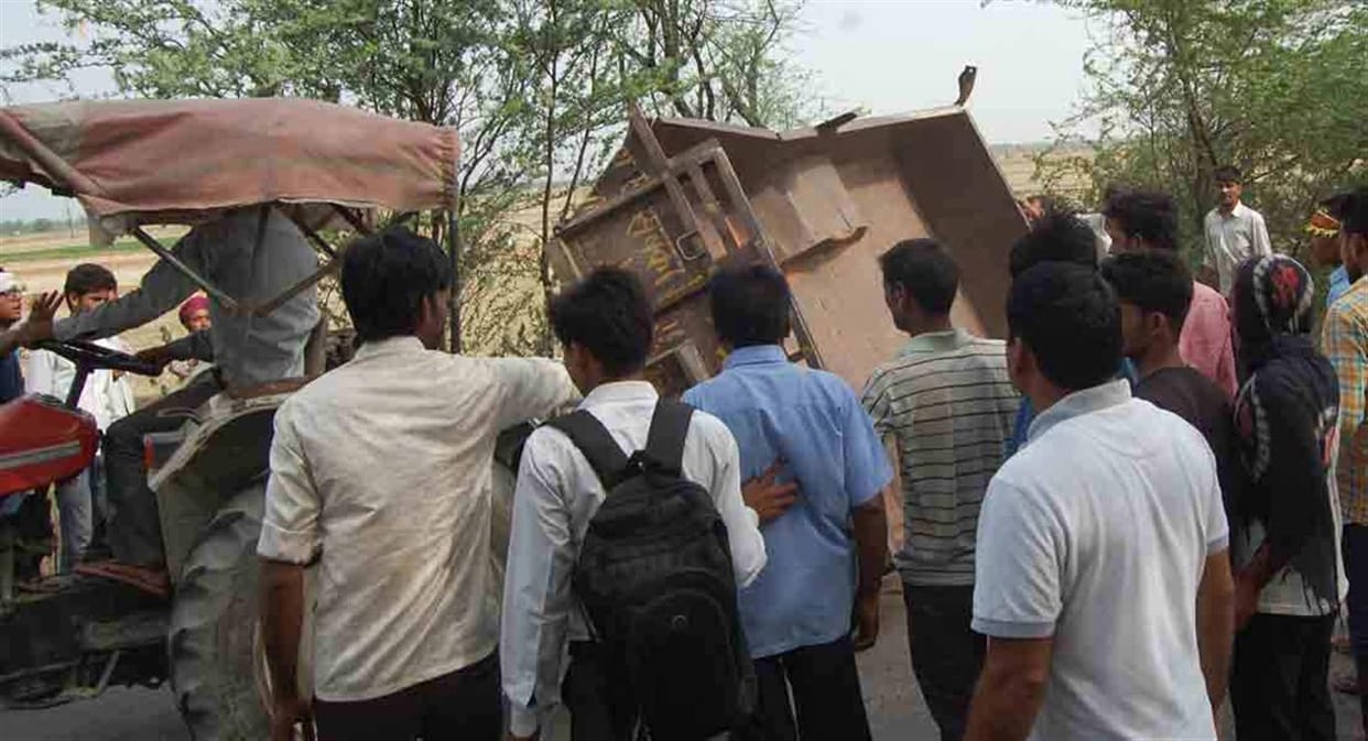 Upturned tractor - trolley , a faithful killed , 11 injured