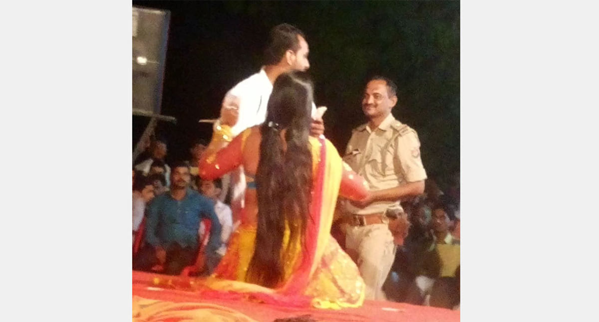 police officer suspended for throwing money on dancing girl