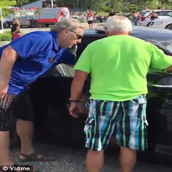 Passer-by uses a rock to smash car window and free a dog locked inside during extreme heat  