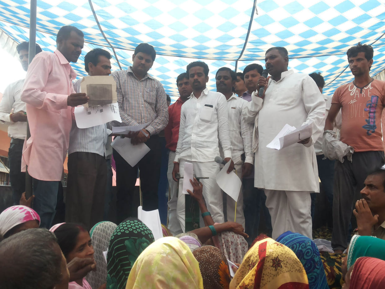 The villagers sat on a dharna ration distribution