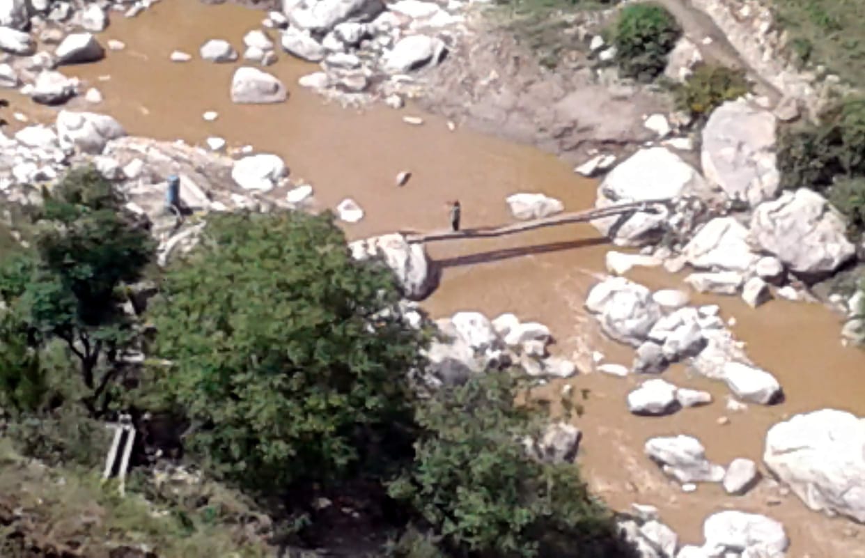 people cross river in bridge.