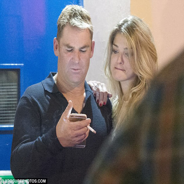 Cricketer Shane Warne shares a steamy smooch kissing in dingy doorway with mystery blonde in London