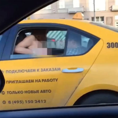 Blush hour traffic as topless woman flashes her boobs at stunned drivers