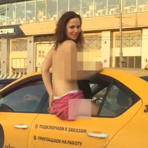 Blush hour traffic as topless woman flashes her boobs at stunned drivers