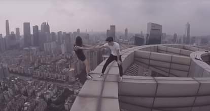 Terrifying video of pair performing stunts atop skyscraper