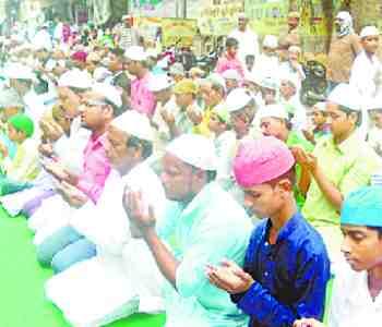 A crowd gathers to pray