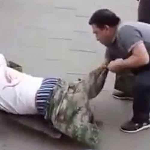 Beggar busted faking his disability after a passerby dragged off his trousers