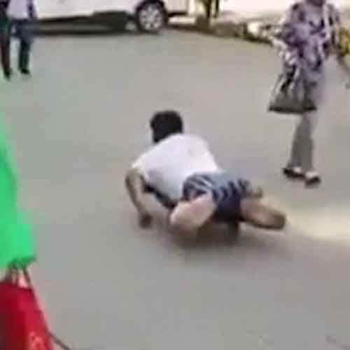 Beggar busted faking his disability after a passerby dragged off his trousers