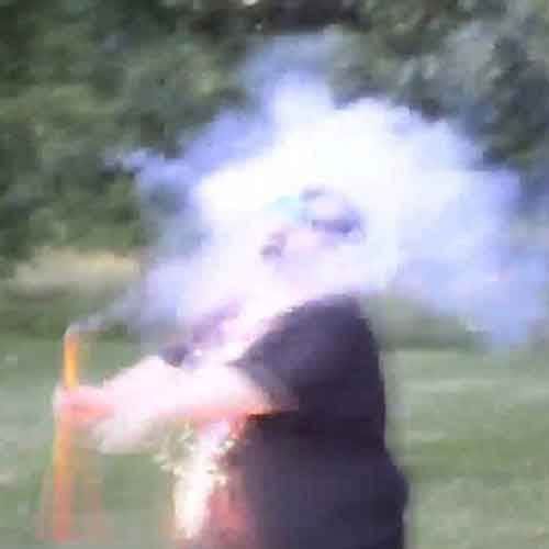 Idiot lights firework under his chin 