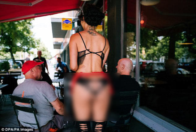 Exhibitionists flock to nude restaurant where staff and guests bare all.