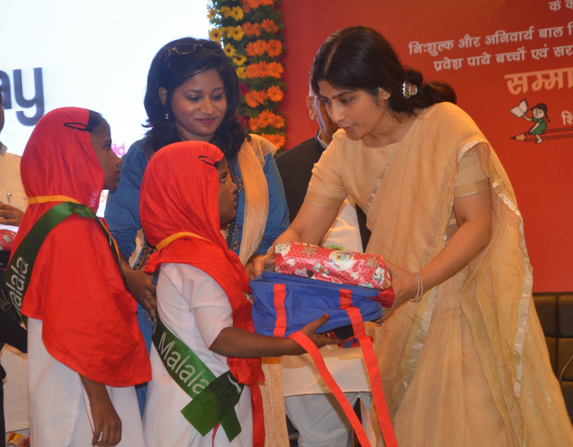 dimple yadav distributes school bags on malala day