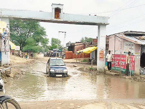 Traffic on the main road from decaying waterlogged miserable