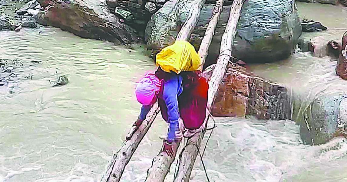 People crossing the river with the help of logs