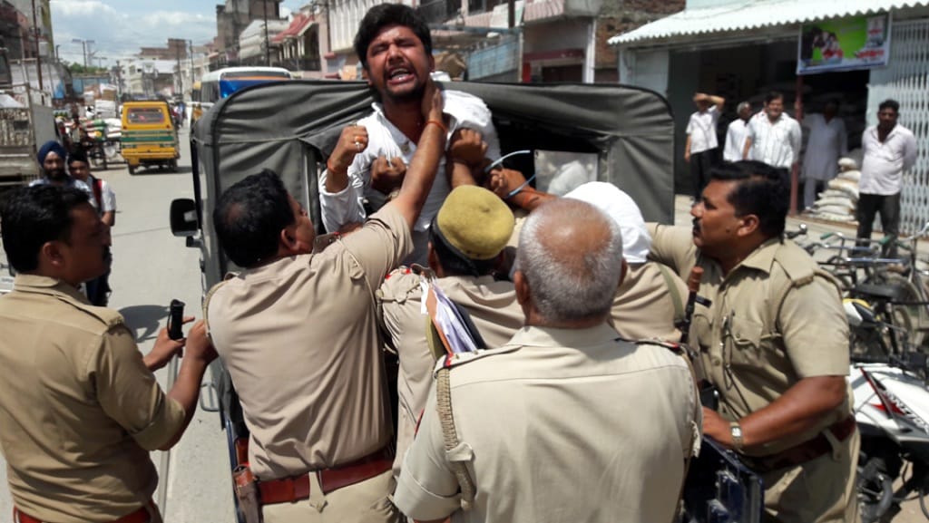 sitting on dharna, three arrested