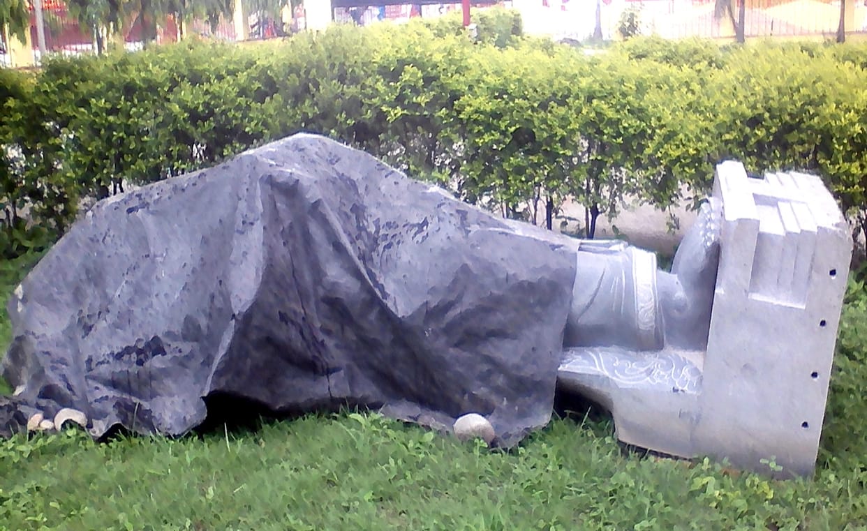 Statue of the saint is lying on the ground