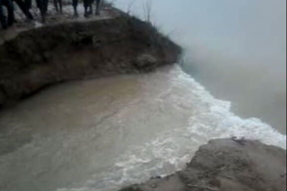 Farmers harvest crops submerged canal