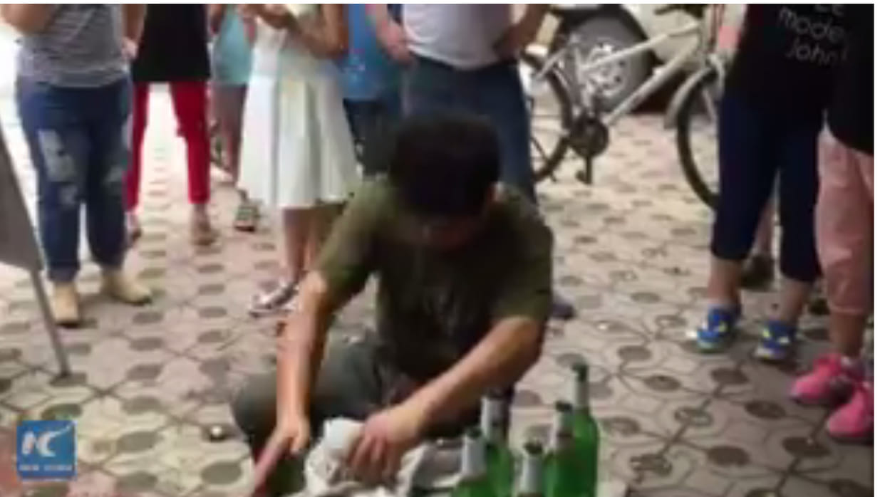 Chinese man breaks beer bottles in half with bare hands