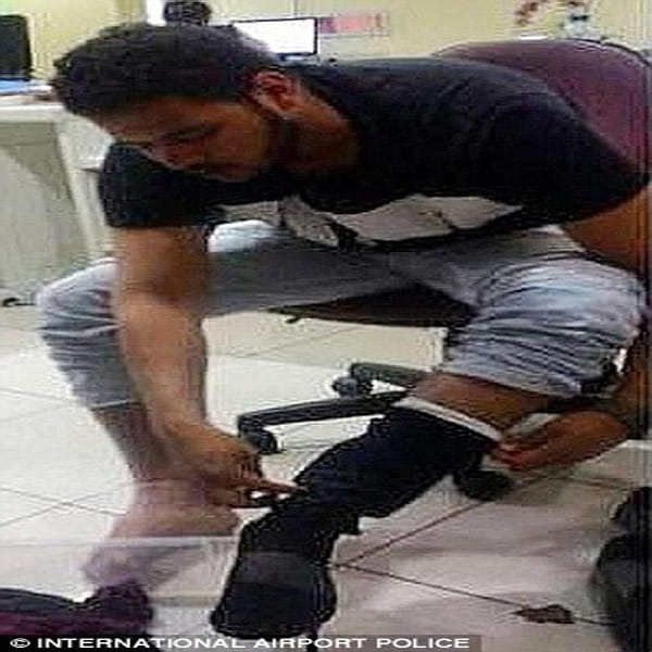 airport officials discovered passenger had hidden ten live pythons down trousers