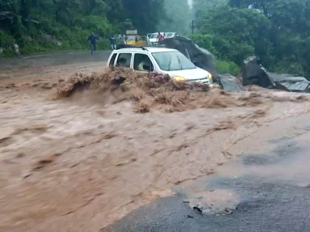 car swept away from the road into river.