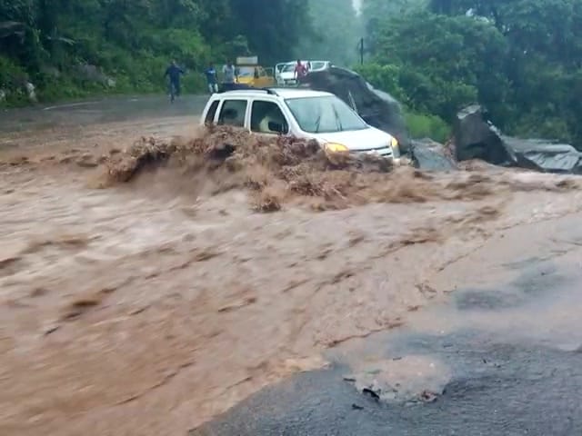 car swept away from the road into river.