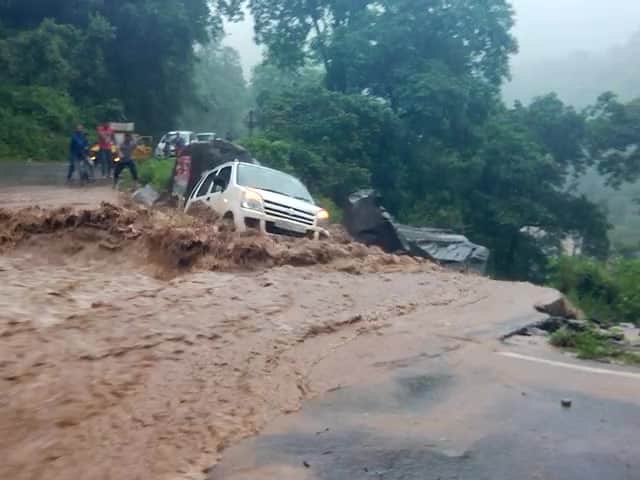 car swept away from the road into river.