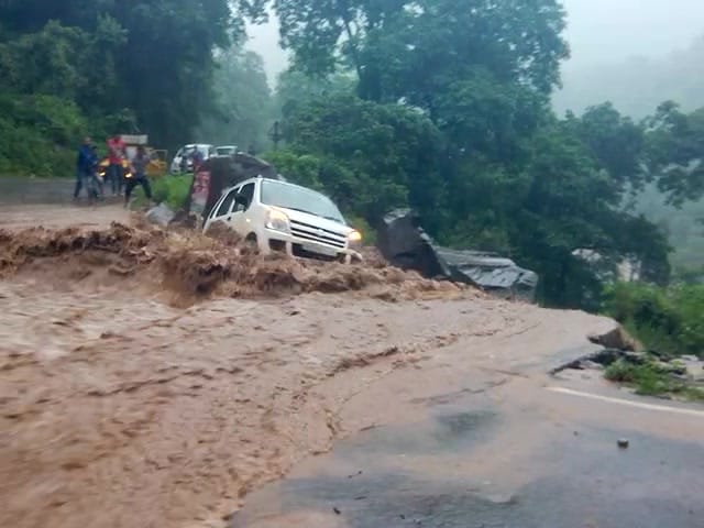 car swept away from the road into river.