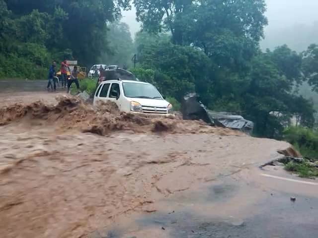 car swept away from the road into river.