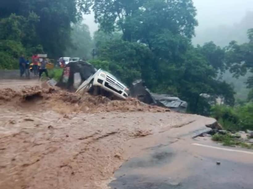 car swept away from the road into river.