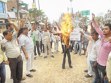 Dhayashankar burned an effigy, demanding arrest