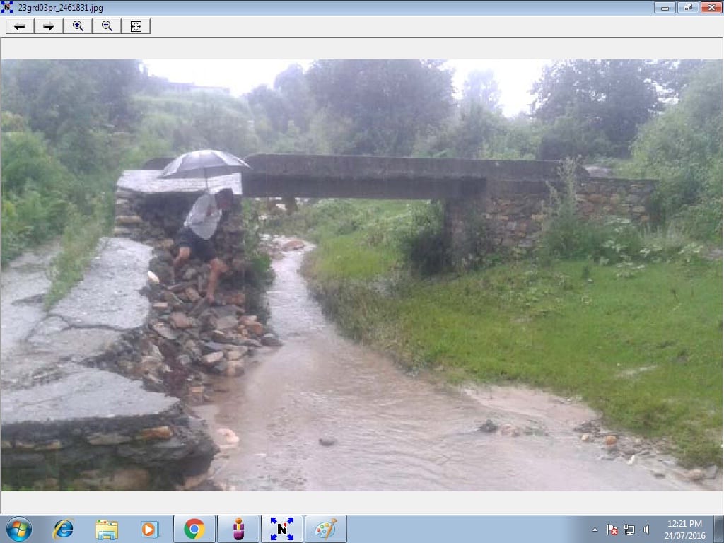 Opened pedestrian bridge connecting the village damaged