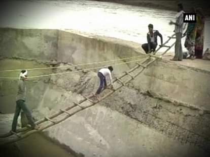 Watch: Locals risk lives crossing raging river on makeshift bridge