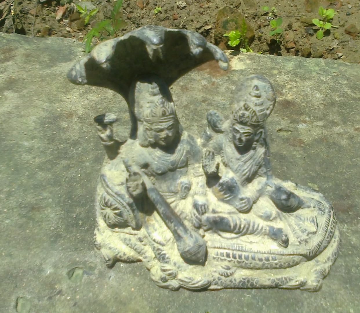 Old statue out of lake