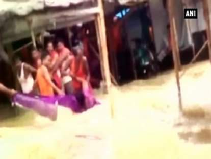 Watch: Flooded river drags woman along its current 